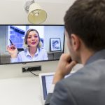 Businessman on video conference with her colleague in office job